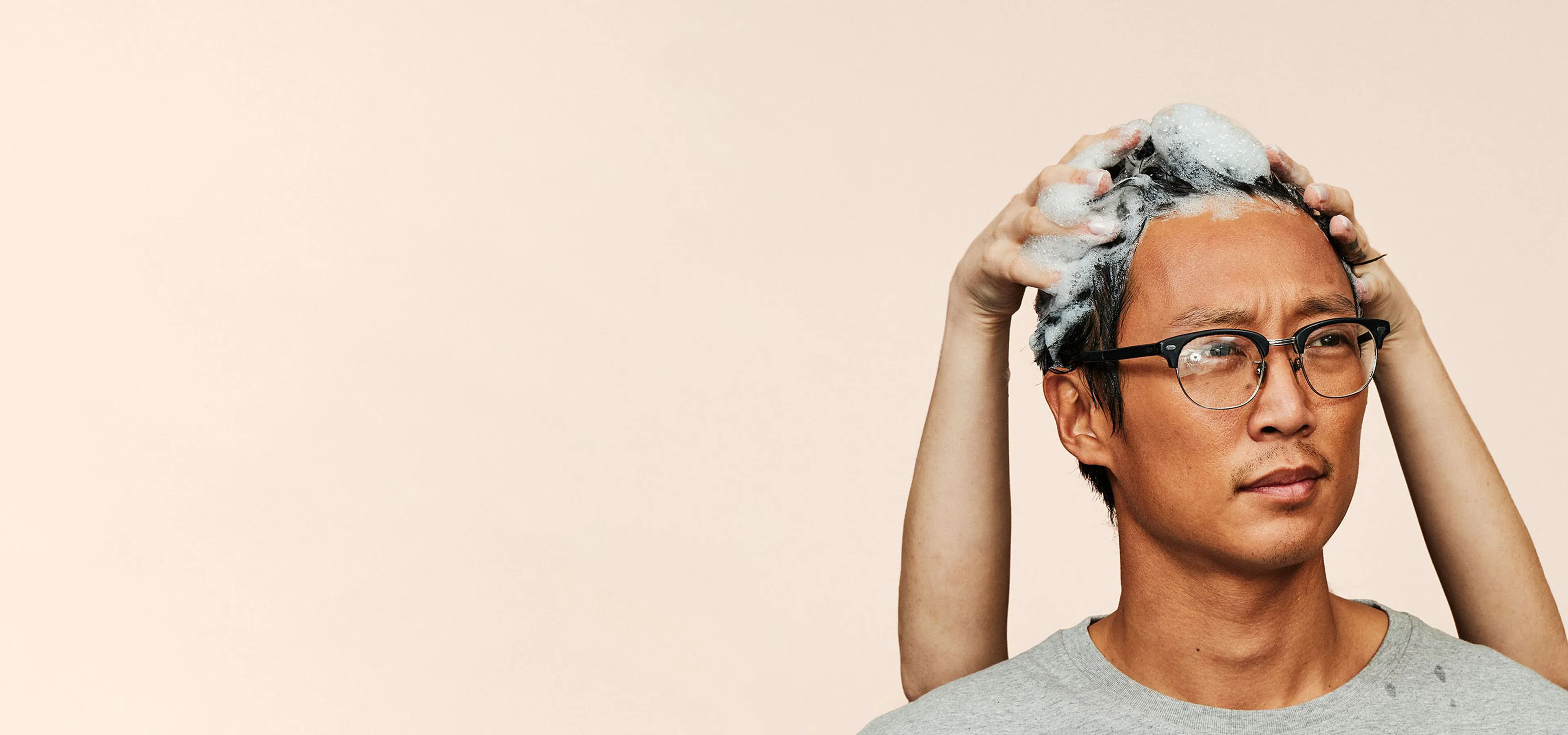 Hims shampoo massaged into a man's hair