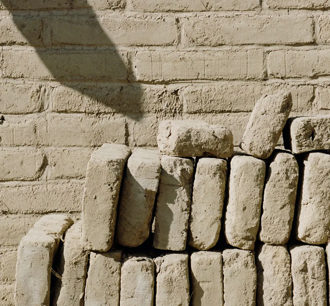 Finished adobe blocks stacked against a wall