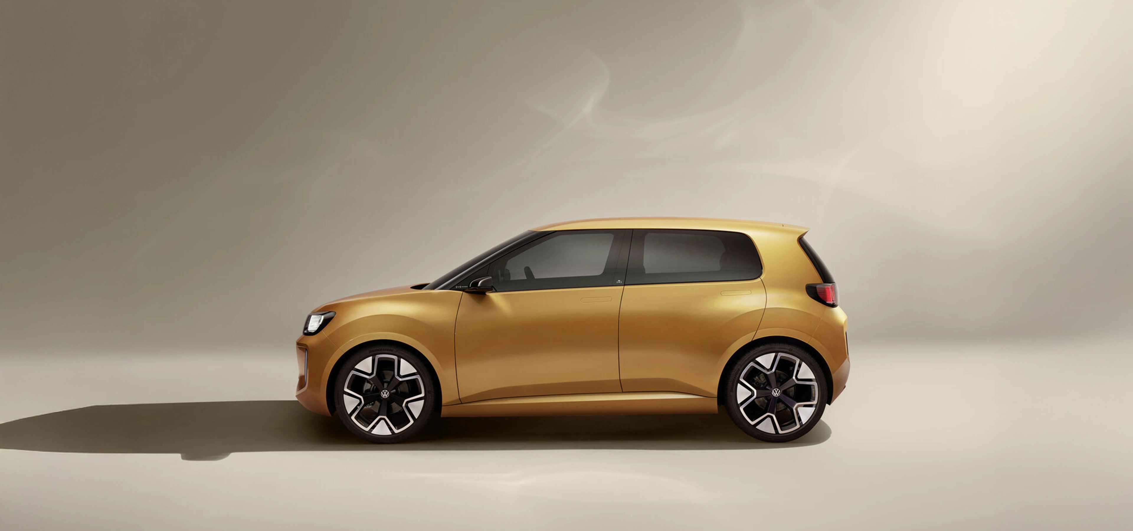 Side view of a small gold coloured car