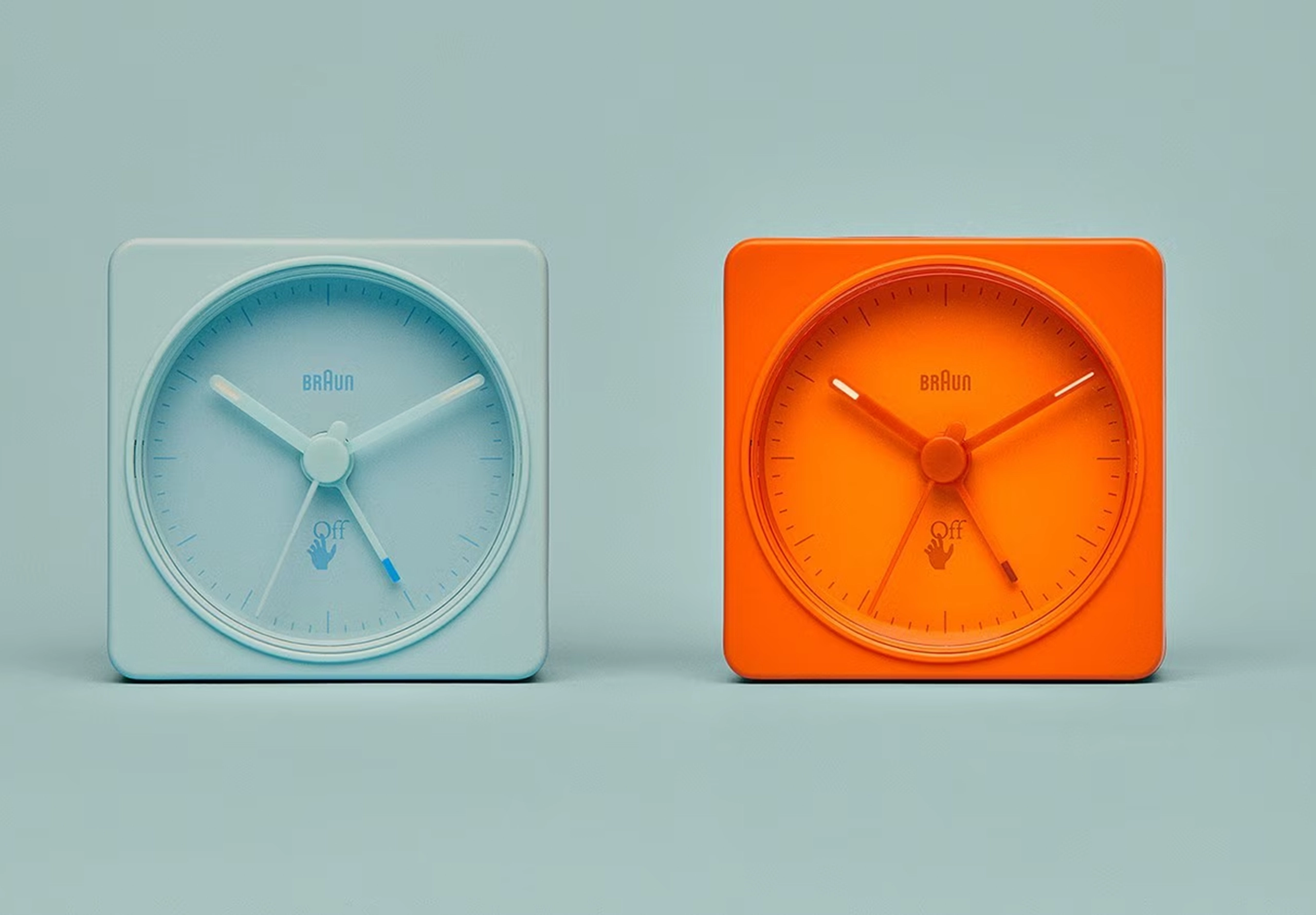 2 colourful alarm clocks on blue background