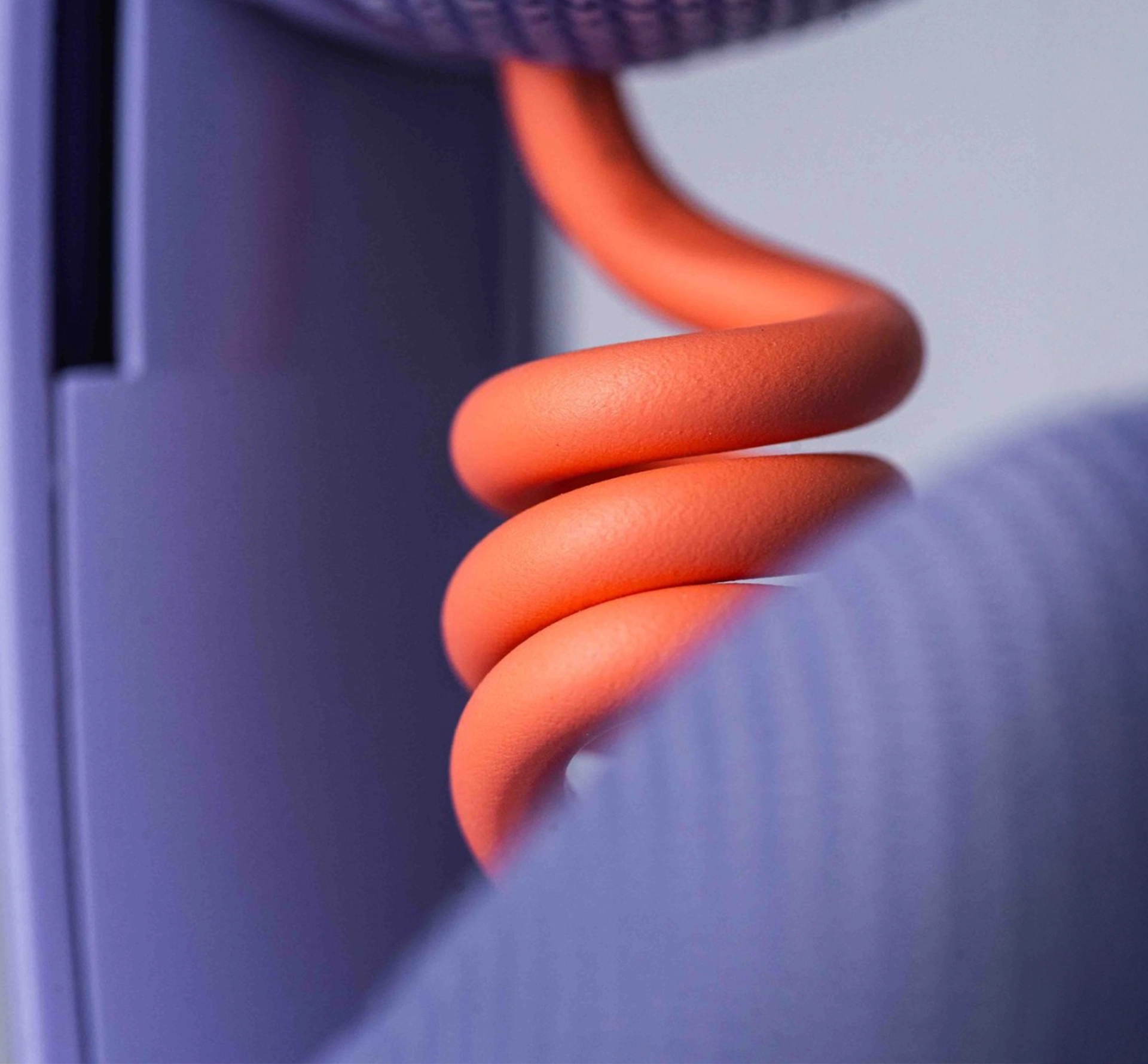 detail of curled orange cable on a headphone